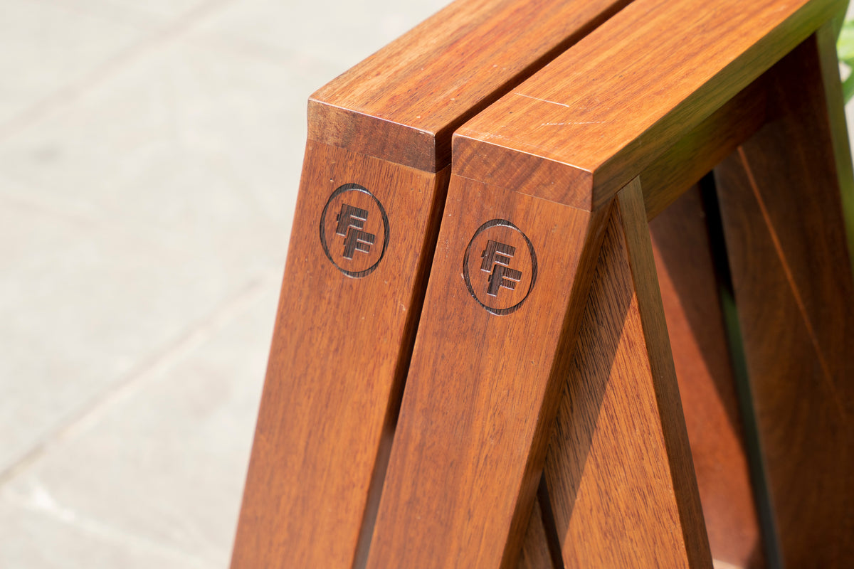 Wooden folding stool with 'FF' logo on a light background